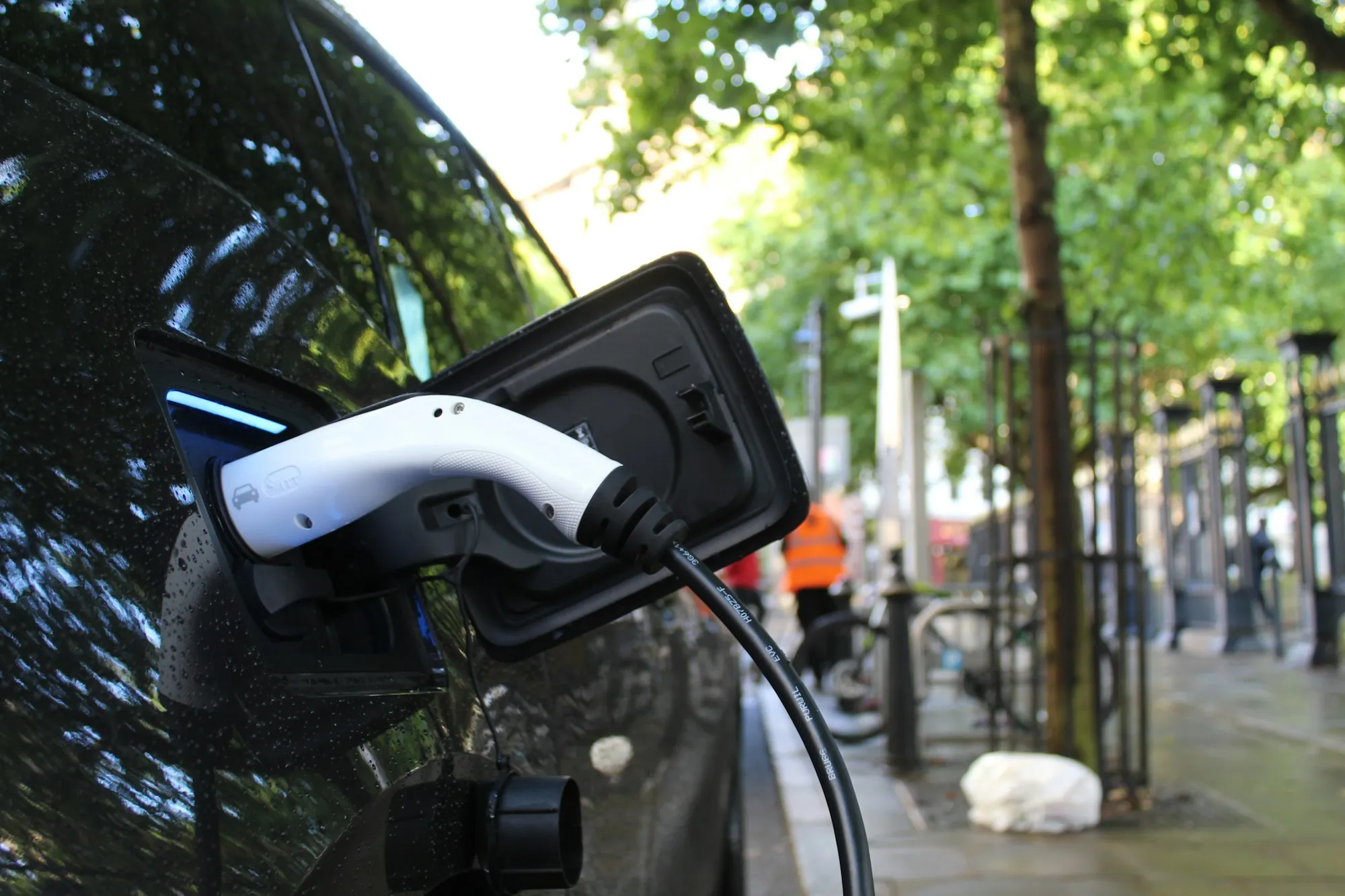 A charging cable connected to a vehicle in a residential setting