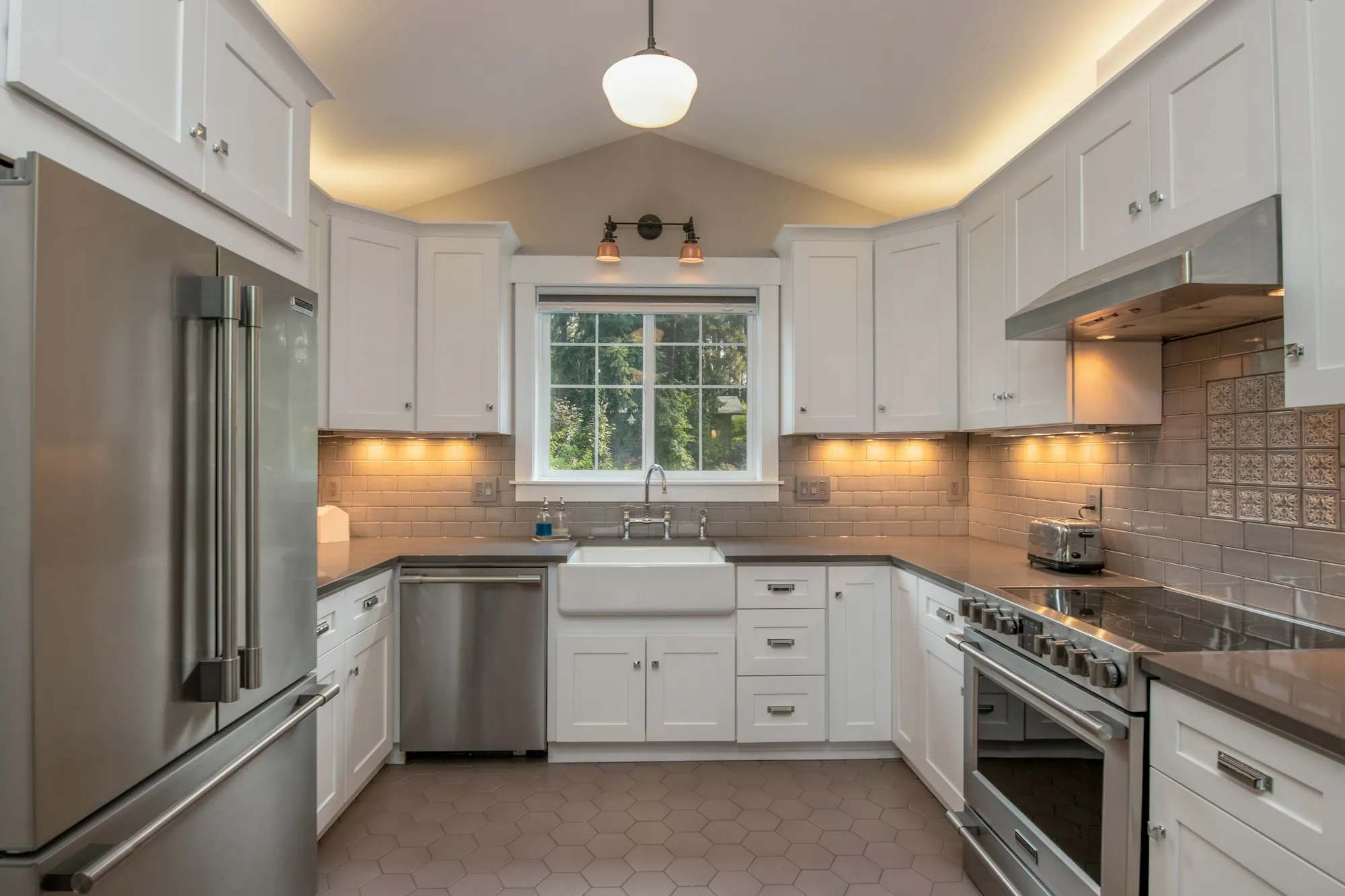 A kitchen with warm under-cabinet lighting