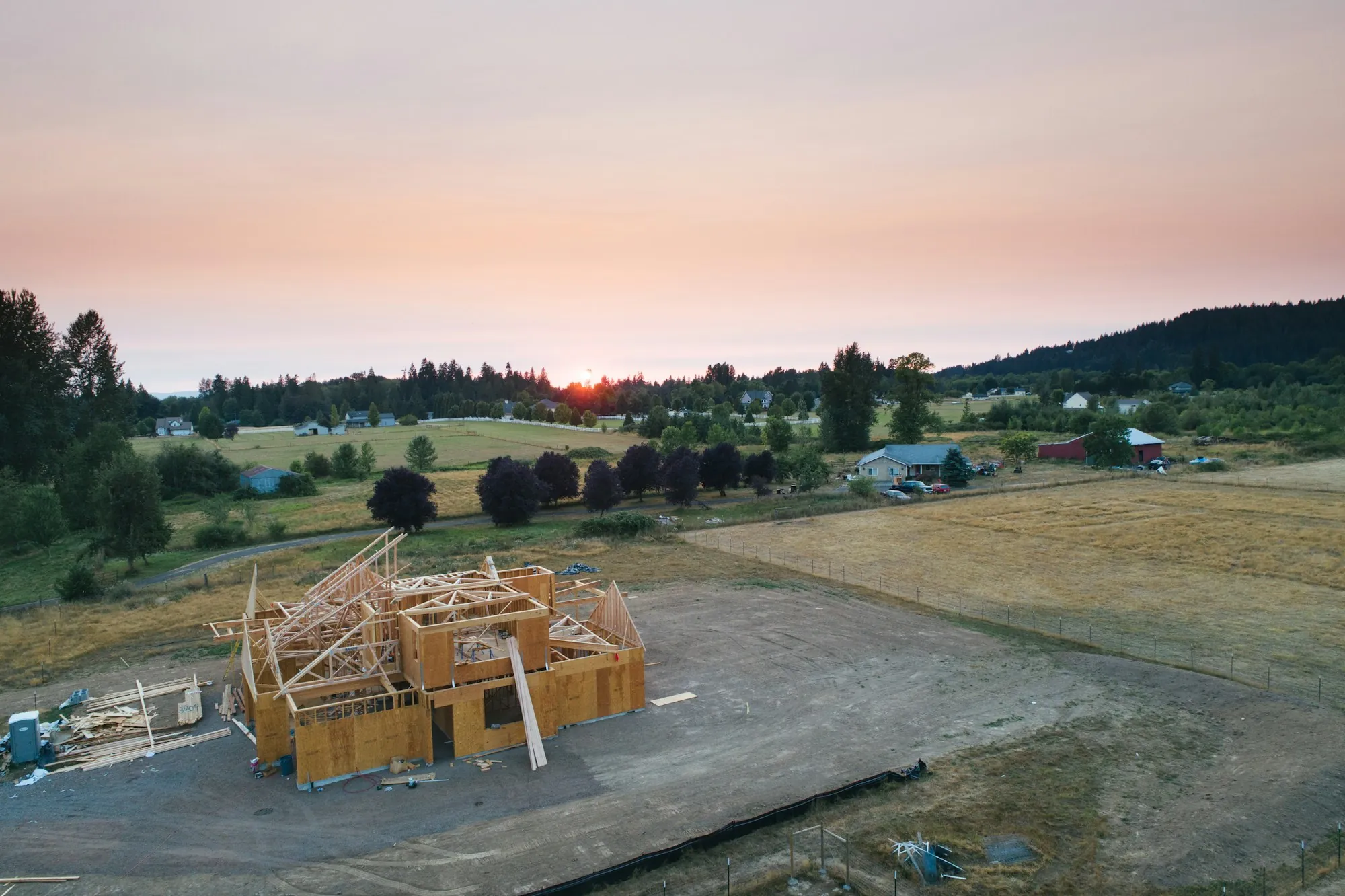 An aerial view of a timber-framed house under construction