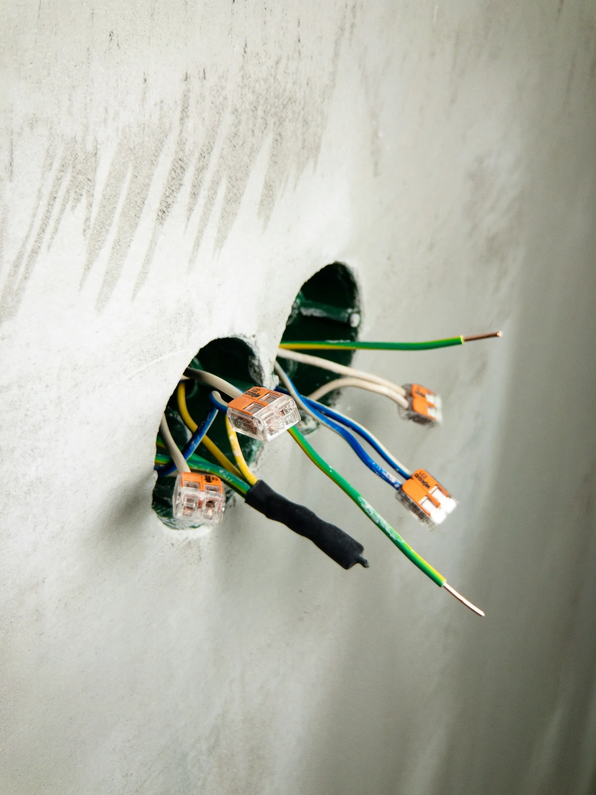 Two wall boxes with loose wires and lever connectors ready for devices